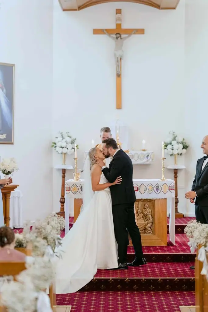Newlyweds embracing at the front of the church