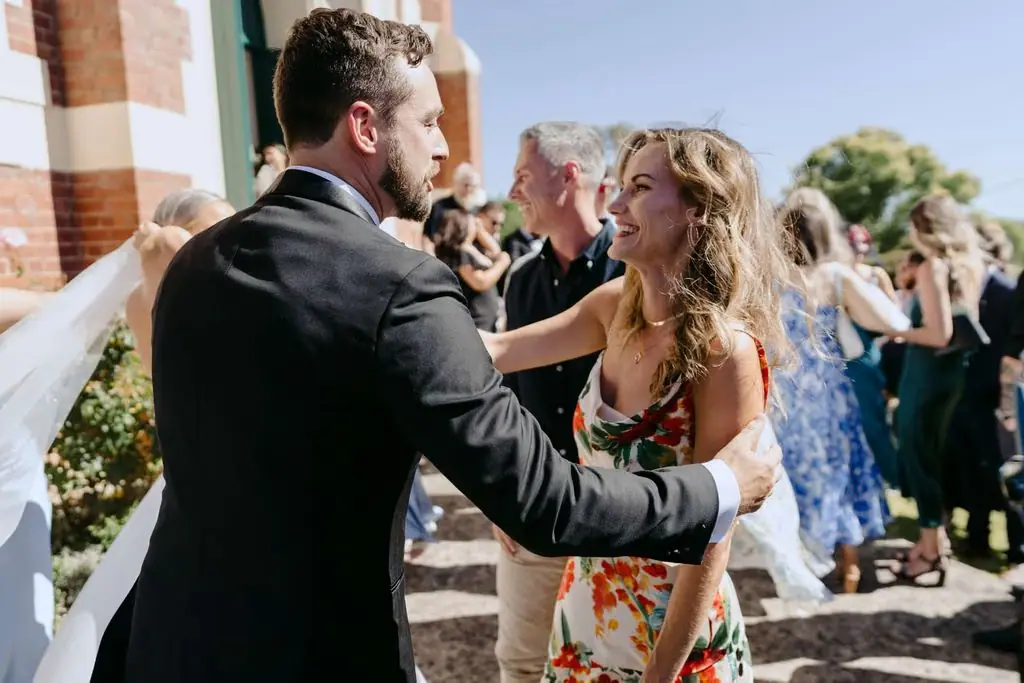 Groom greeting a guest outside the church