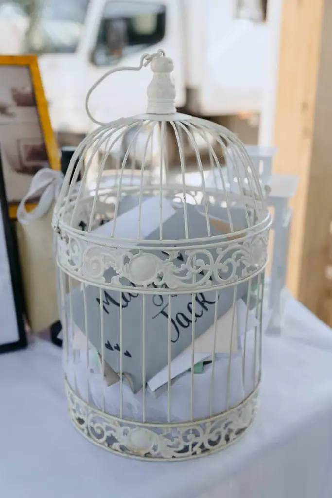 Wedding cards collected in a decorative white birdcage