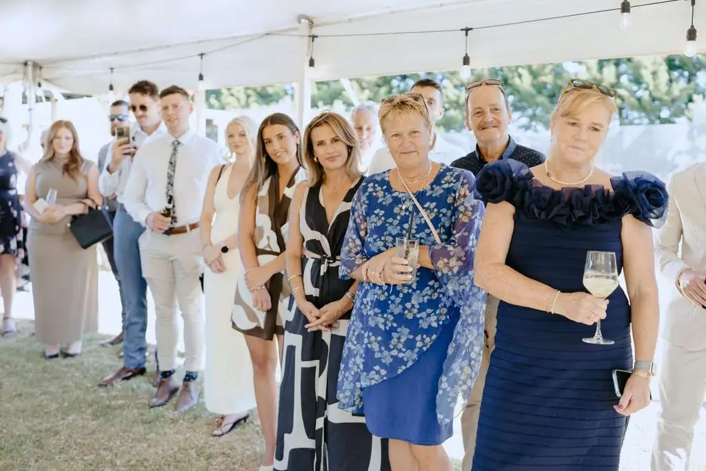 Guests standing and watching the reception speeches