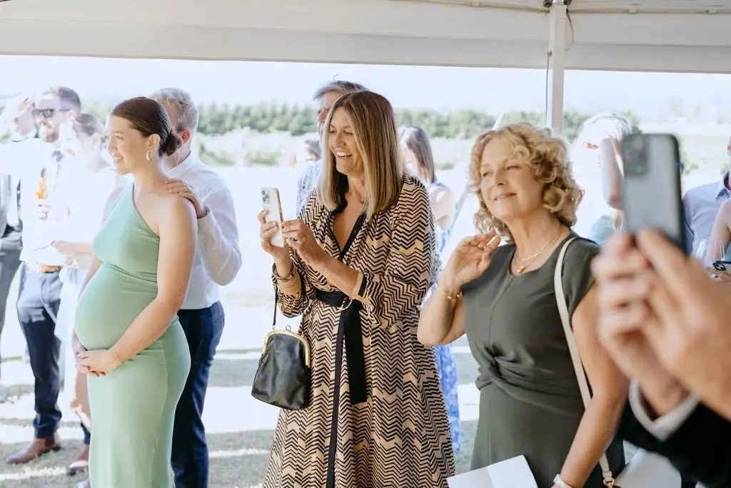 Guests smiling during a reception speech