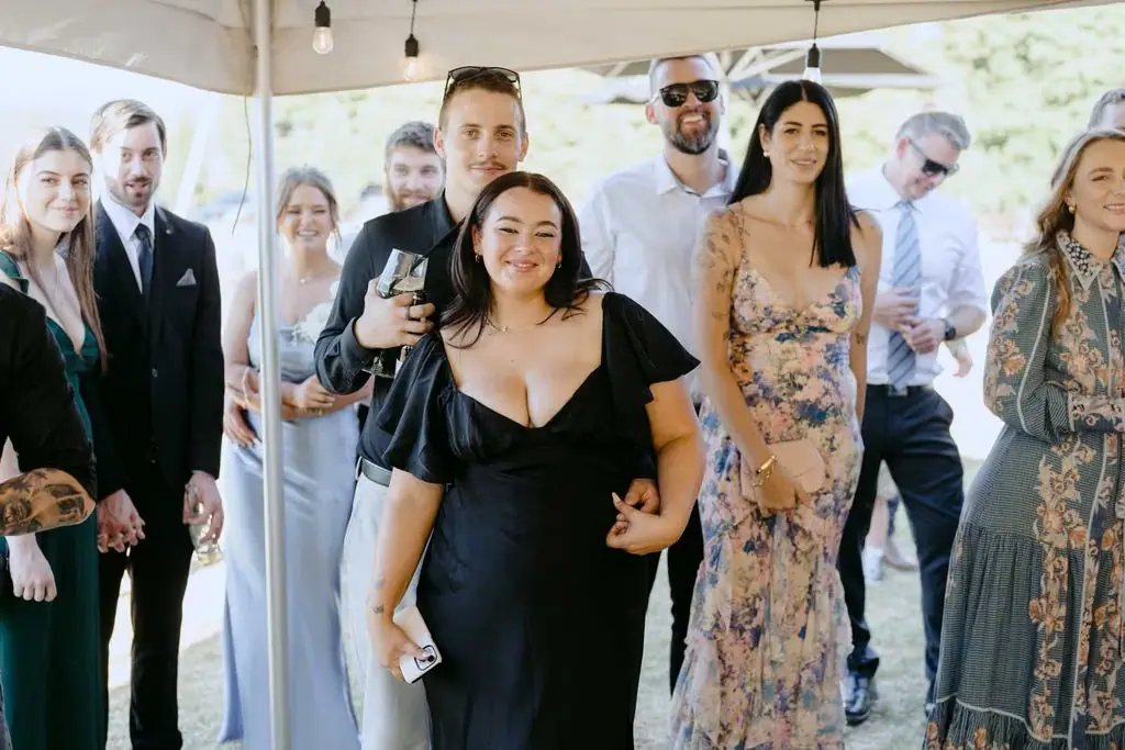 Guests standing together beneath the reception marquee