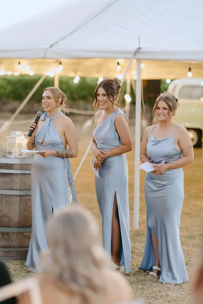 Three bridesmaids standing together for a reception speech