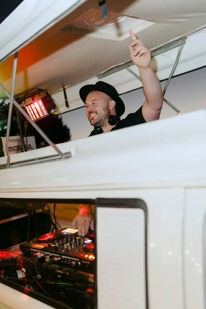 Guest raising an arm from a vehicle fitted with sound equipment