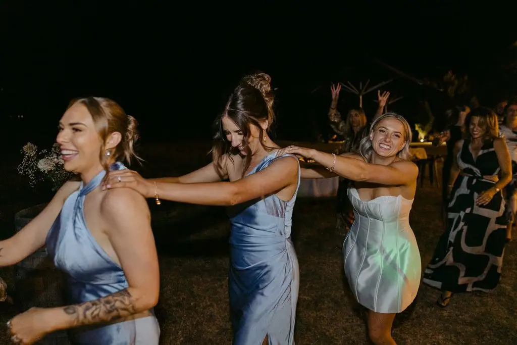 Bridesmaids dancing together in a line