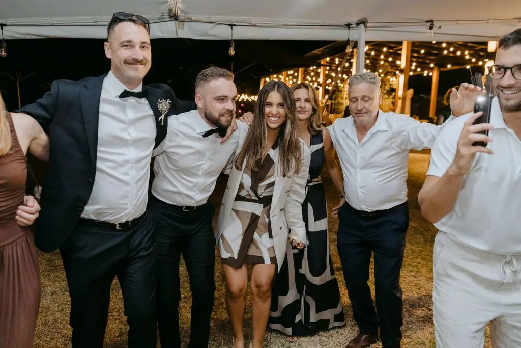 Guests posing together and smiling at the reception