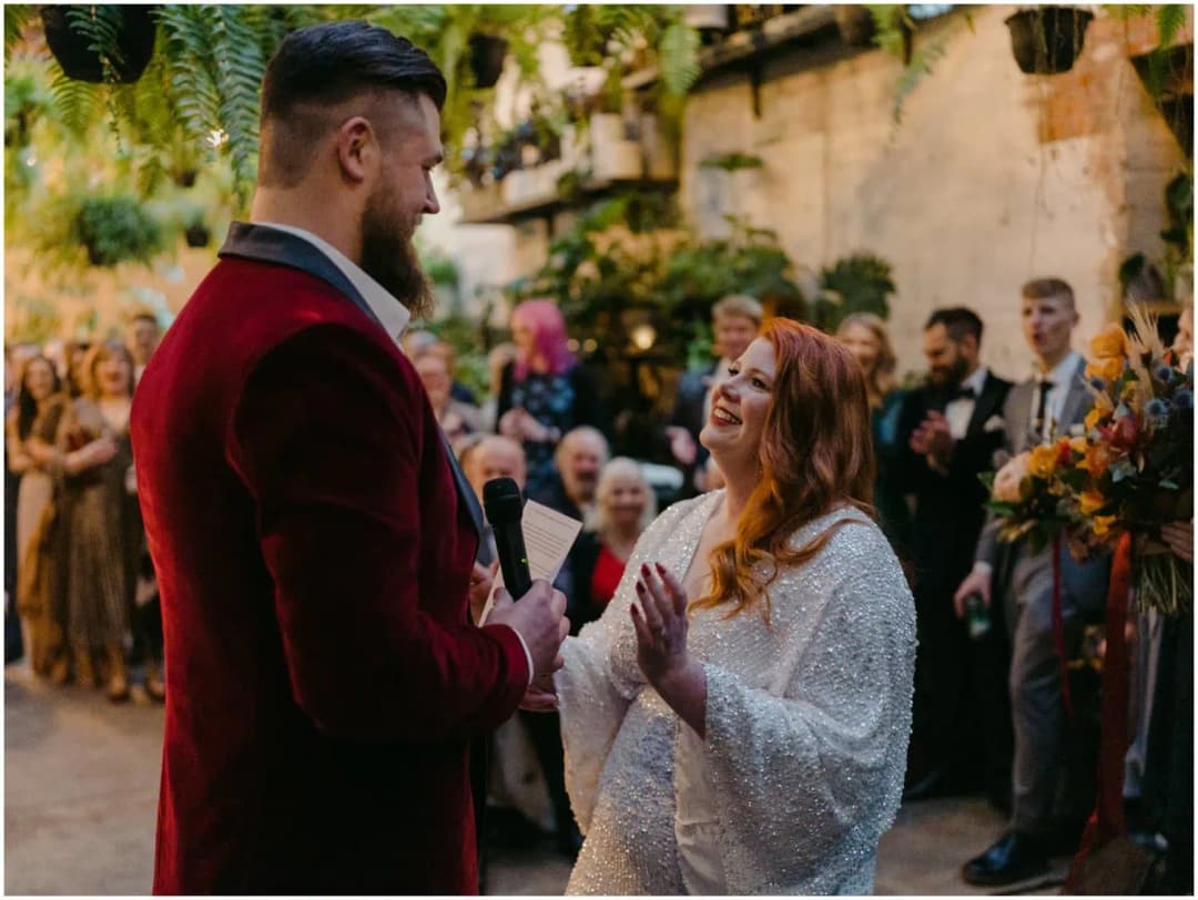 Bride laughing while facing the groom during their ceremony